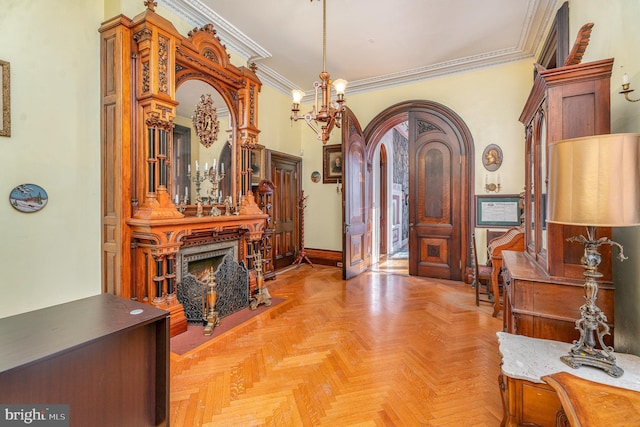 entrance foyer featuring crown molding, a chandelier, and light parquet floors