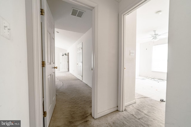 hallway featuring light carpet