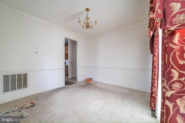 carpeted spare room featuring crown molding and an inviting chandelier