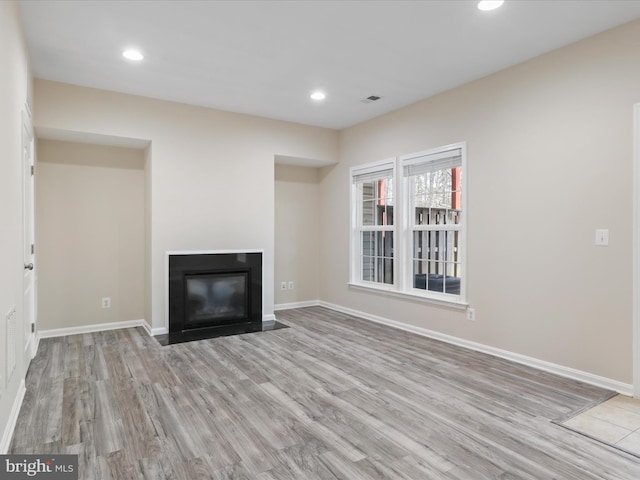 unfurnished living room featuring light wood-type flooring