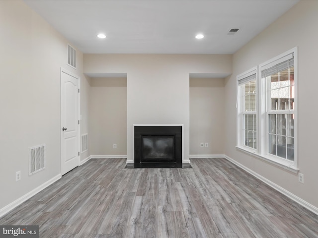 unfurnished living room featuring light hardwood / wood-style flooring