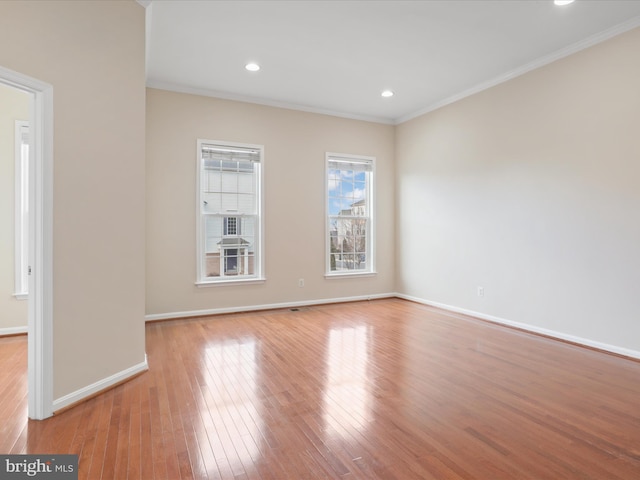 spare room featuring light hardwood / wood-style flooring and ornamental molding