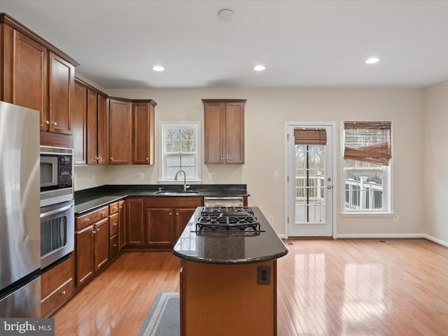 kitchen featuring a kitchen island, a healthy amount of sunlight, appliances with stainless steel finishes, and sink