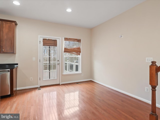 unfurnished dining area featuring light hardwood / wood-style flooring