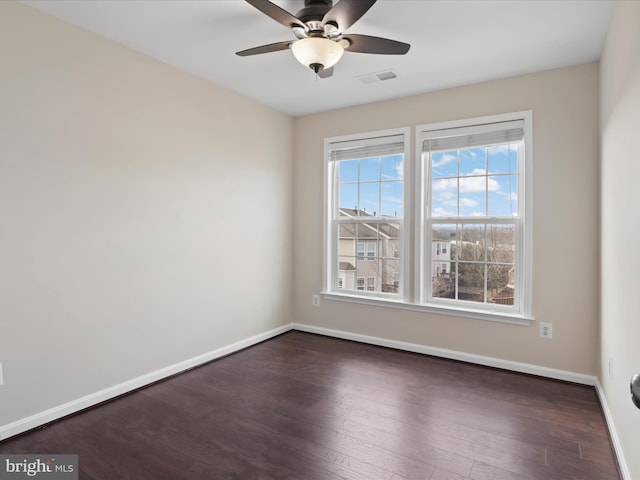 empty room featuring ceiling fan and dark hardwood / wood-style floors