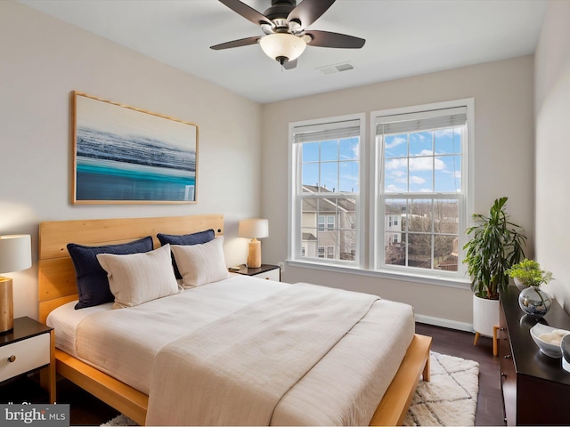 bedroom with dark wood-type flooring and ceiling fan