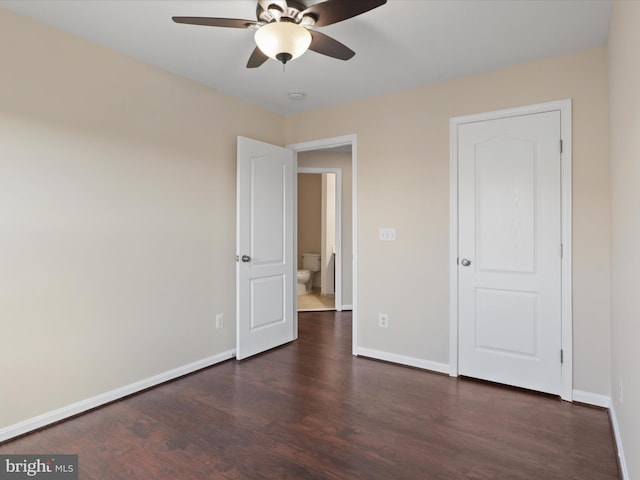 unfurnished bedroom featuring ceiling fan and dark hardwood / wood-style flooring