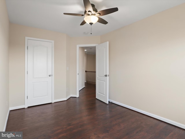 unfurnished bedroom with ceiling fan and dark hardwood / wood-style floors