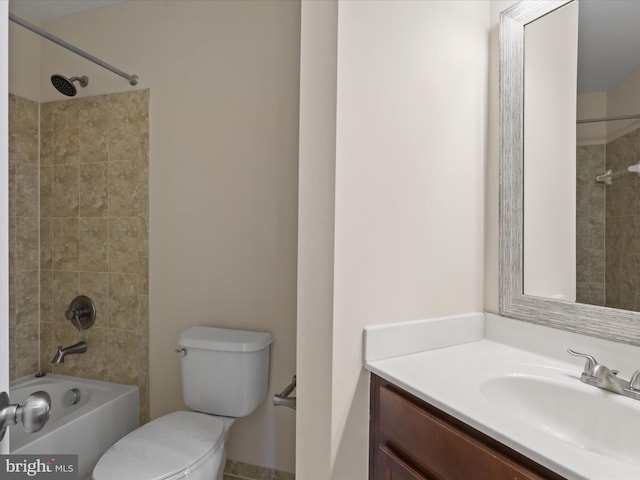 full bathroom featuring vanity, tiled shower / bath combo, and toilet