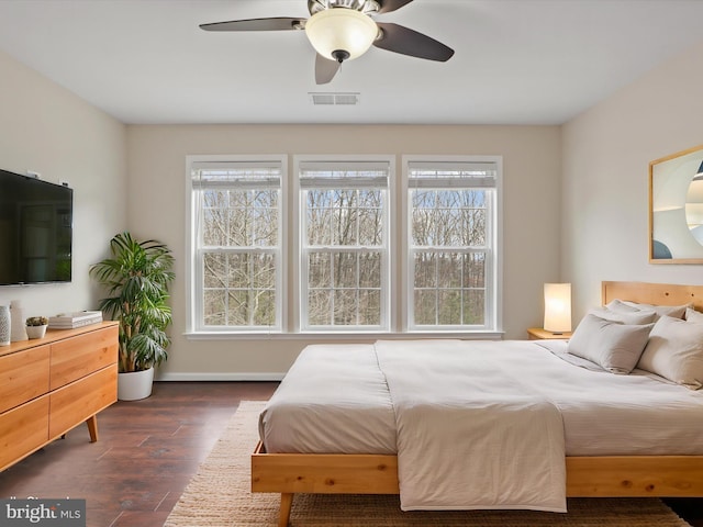 bedroom featuring ceiling fan and dark hardwood / wood-style flooring