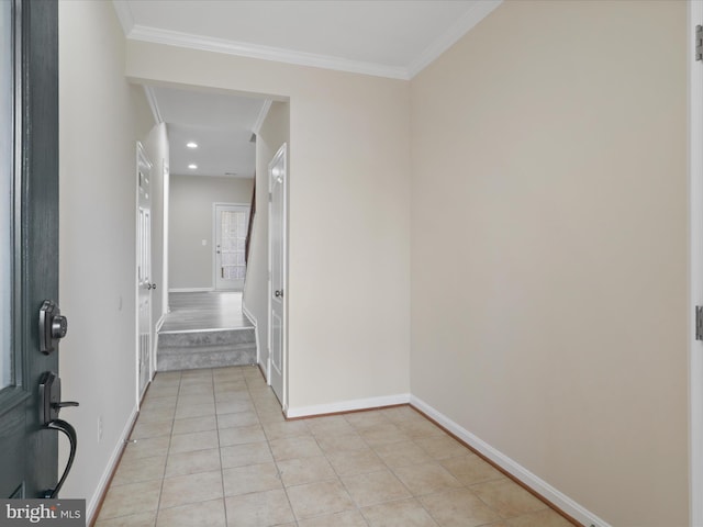 interior space with ornamental molding and light tile patterned floors