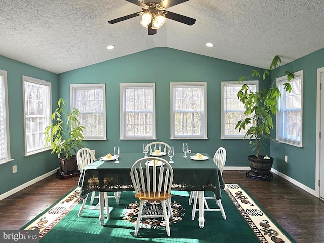 dining room with plenty of natural light, dark hardwood / wood-style floors, and vaulted ceiling