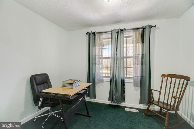 home office featuring dark carpet and a textured ceiling