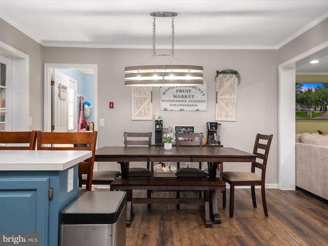 dining area with dark wood-type flooring and crown molding