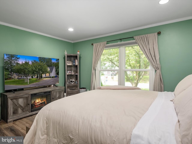 bedroom with hardwood / wood-style flooring and ornamental molding