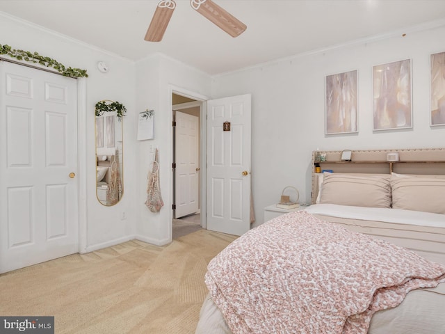 carpeted bedroom with crown molding and ceiling fan