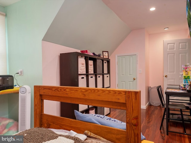 bedroom with vaulted ceiling and hardwood / wood-style floors