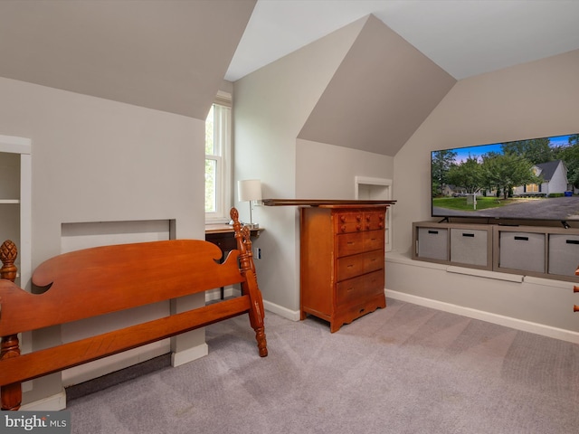 bedroom with light carpet and vaulted ceiling