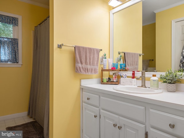 bathroom featuring tile patterned flooring, ornamental molding, and vanity