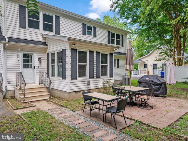 rear view of house with a patio and central AC