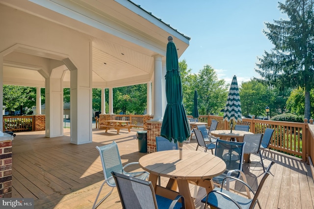 wooden terrace featuring outdoor dining area