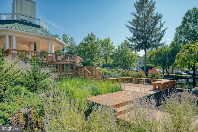 surrounding community with a deck and stairs