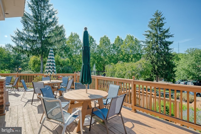 wooden terrace featuring outdoor dining area