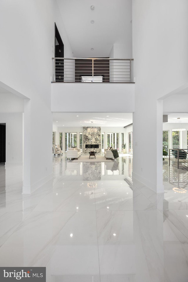 interior space featuring a towering ceiling and a healthy amount of sunlight