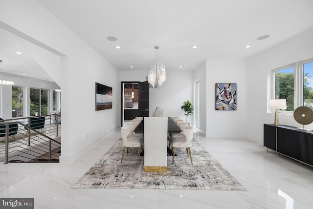 dining area featuring a healthy amount of sunlight and an inviting chandelier