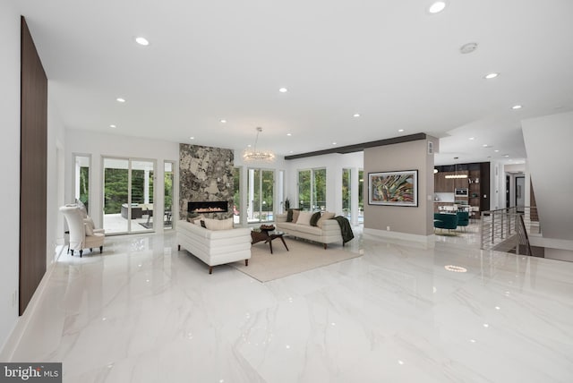 living room featuring a notable chandelier and a fireplace