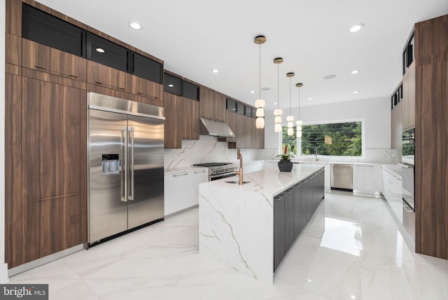 kitchen with hanging light fixtures, a center island, high quality appliances, light stone counters, and white cabinets