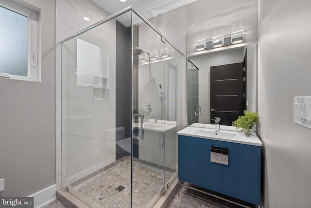 bathroom featuring vanity and a shower with shower door