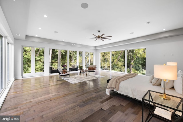 bedroom featuring multiple windows and hardwood / wood-style flooring