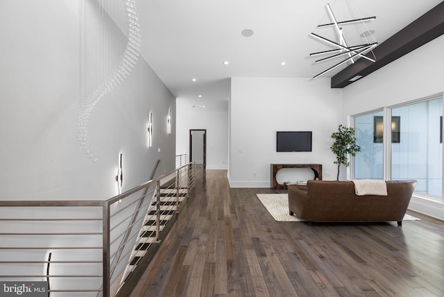 living room with a notable chandelier and dark hardwood / wood-style flooring