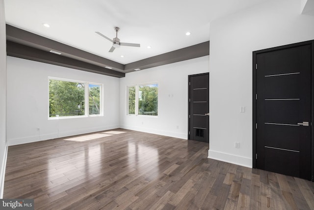 empty room featuring dark hardwood / wood-style flooring and ceiling fan