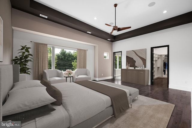 bedroom with dark wood-type flooring, ceiling fan, a spacious closet, and multiple windows