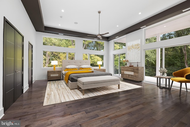 bedroom featuring dark wood-type flooring and a towering ceiling