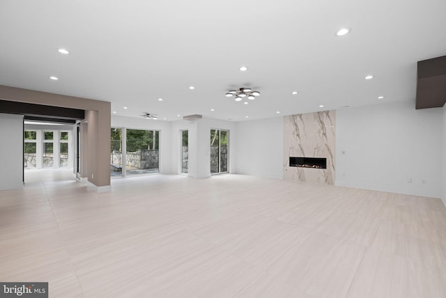 unfurnished living room featuring a premium fireplace