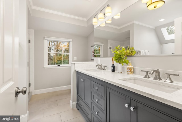 bathroom with a sink, a skylight, and ornamental molding