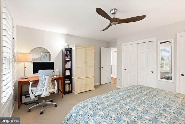 bedroom with ceiling fan and light colored carpet