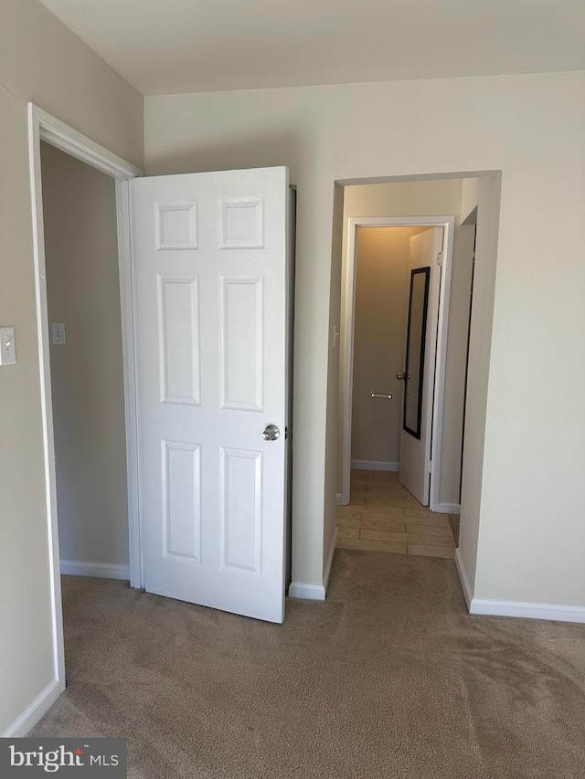 unfurnished bedroom with carpet floors