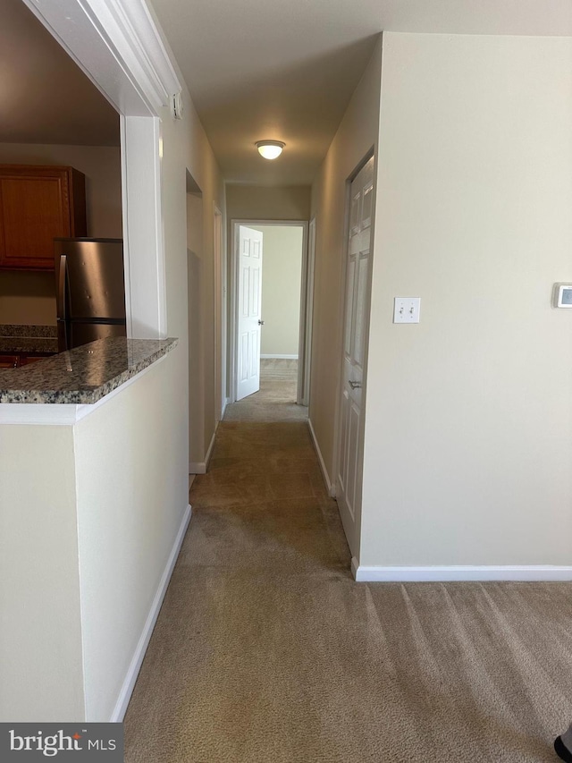 corridor with light colored carpet