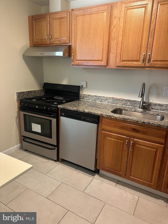 kitchen with sink, light tile patterned floors, and appliances with stainless steel finishes