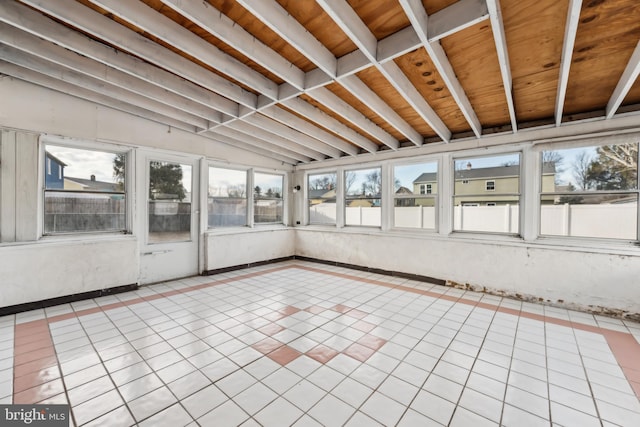 unfurnished sunroom with vaulted ceiling