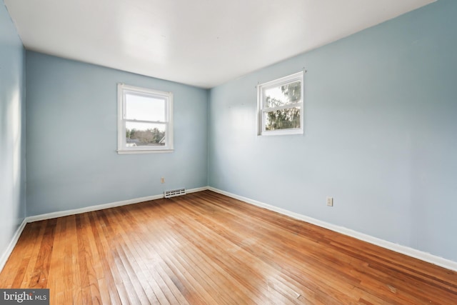 spare room with light hardwood / wood-style flooring and a healthy amount of sunlight