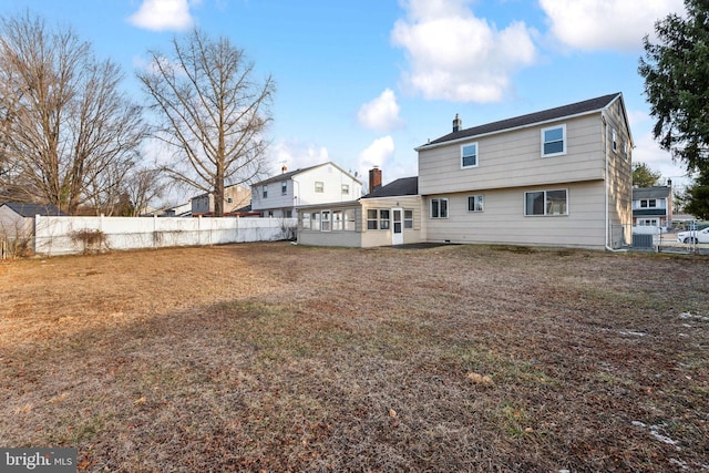 back of property with a sunroom