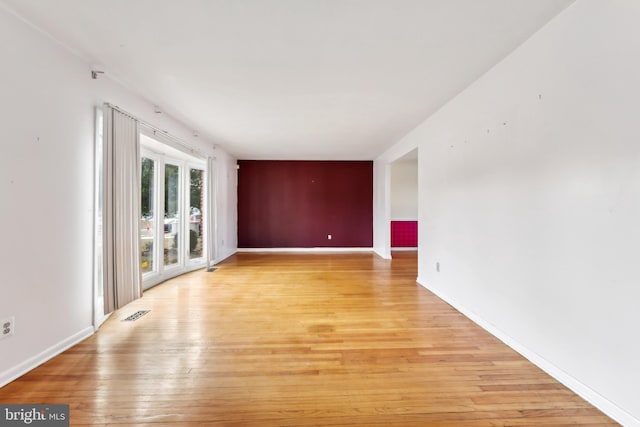 spare room featuring light hardwood / wood-style floors