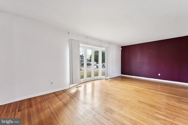 unfurnished room with light wood-type flooring