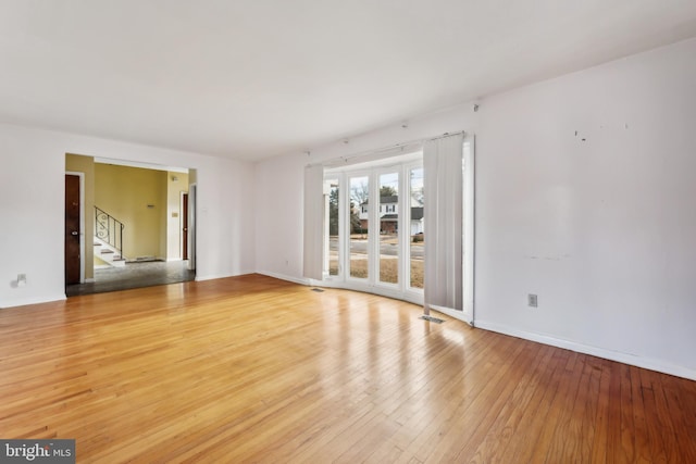 empty room with hardwood / wood-style floors