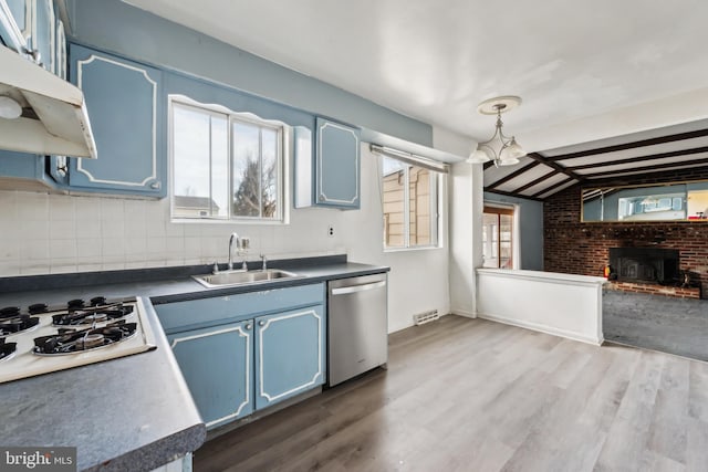 kitchen with sink, blue cabinetry, dishwasher, hanging light fixtures, and white gas stovetop